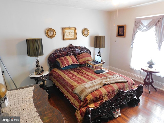 bedroom with hardwood / wood-style flooring