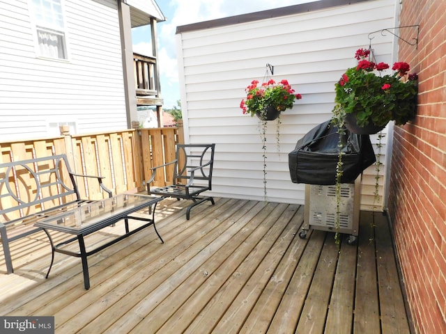 wooden deck featuring a grill