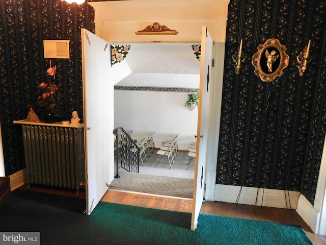 interior space with radiator heating unit and dark wood-type flooring