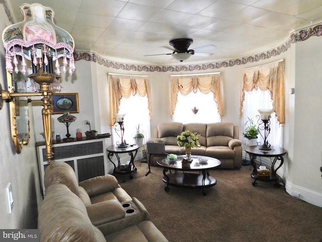 carpeted living room with ceiling fan and plenty of natural light