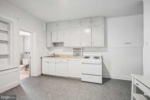 kitchen with white cabinetry, sink, and white gas stove