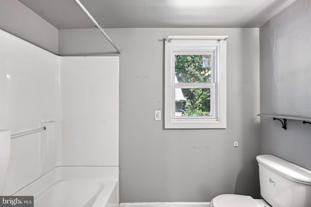 bathroom featuring shower / bathing tub combination and toilet