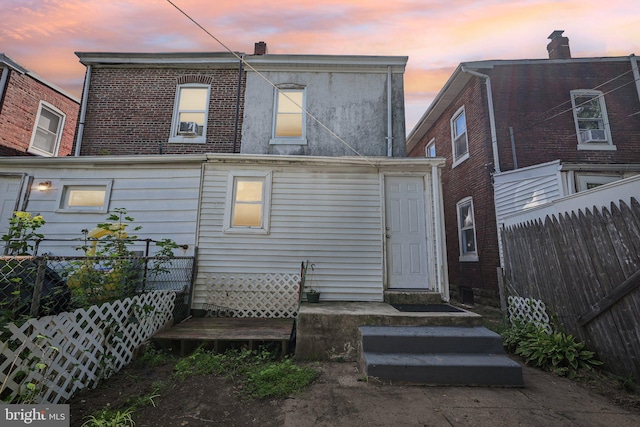 view of back house at dusk