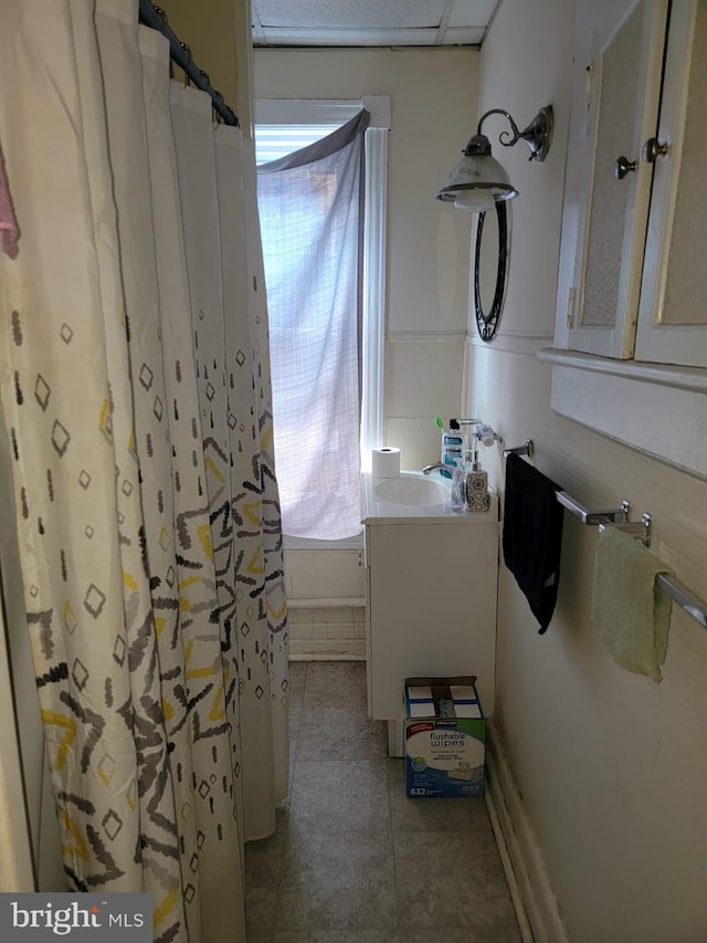 bathroom featuring plenty of natural light, curtained shower, tile patterned flooring, and vanity