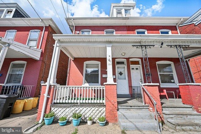 townhome / multi-family property featuring a porch