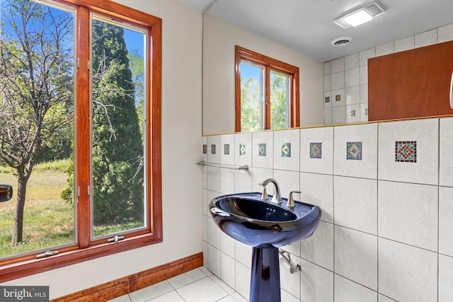 bathroom with tile walls and tile patterned flooring