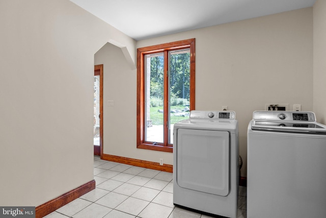 washroom featuring separate washer and dryer and light tile patterned floors