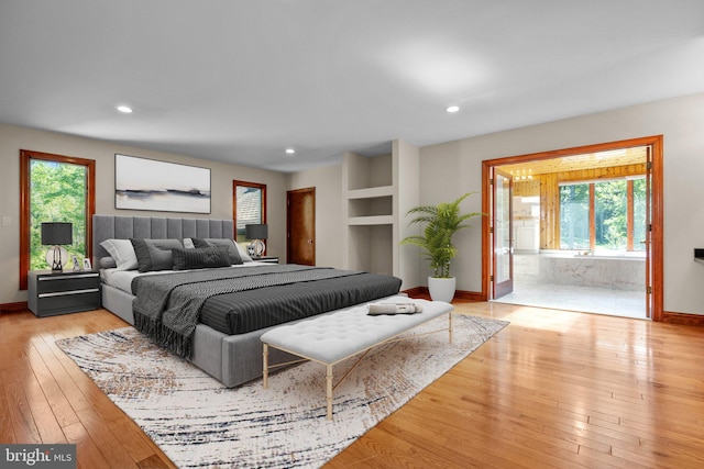 bedroom featuring multiple windows and light hardwood / wood-style flooring