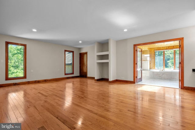 unfurnished living room featuring light hardwood / wood-style flooring and a healthy amount of sunlight