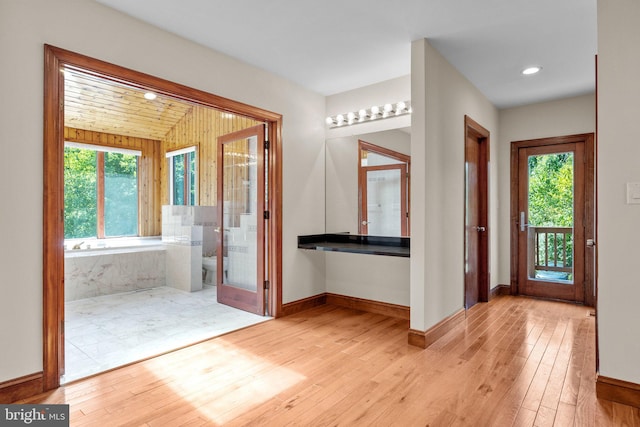 entrance foyer with light hardwood / wood-style flooring and a wealth of natural light