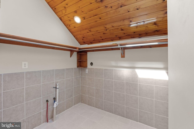 laundry room with wood ceiling, light tile patterned floors, and tile walls