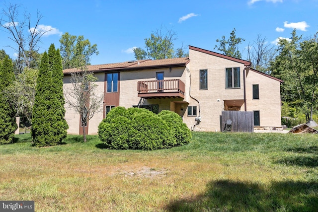 back of house with a lawn