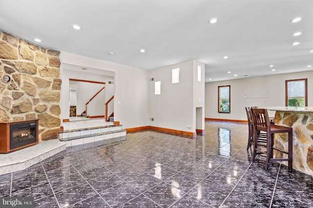 living room with a stone fireplace