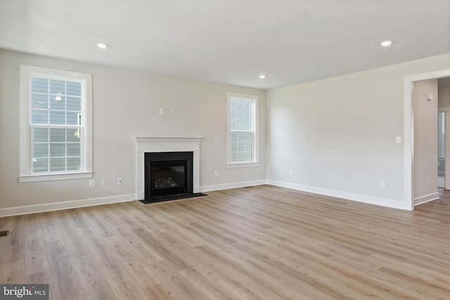 unfurnished living room with light hardwood / wood-style flooring