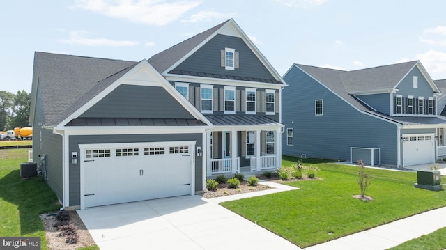 craftsman inspired home featuring a front yard, central AC, and a garage