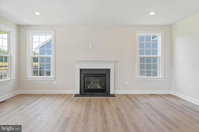 unfurnished living room with light hardwood / wood-style flooring