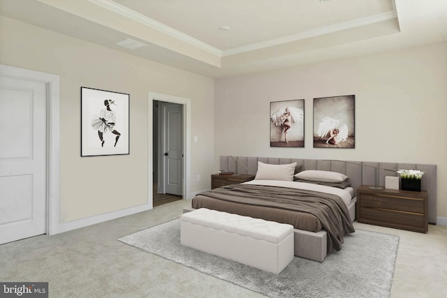 carpeted bedroom featuring a tray ceiling and ornamental molding