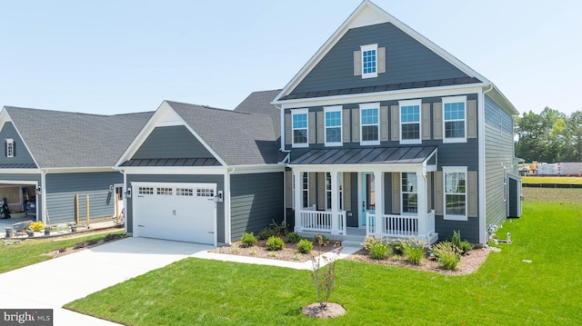 view of front of house with a porch, a front lawn, and a garage