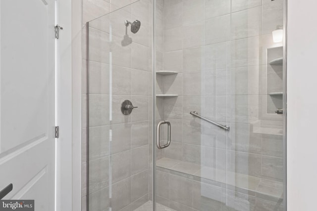 bathroom with a shower with shower door