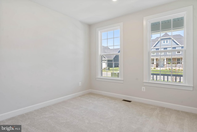 unfurnished room with light colored carpet