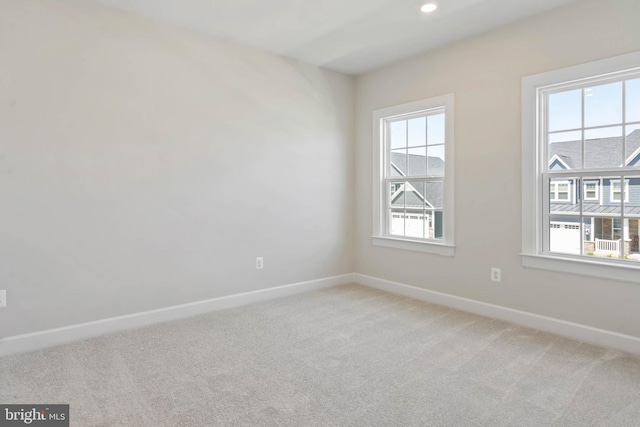 carpeted spare room featuring a wealth of natural light