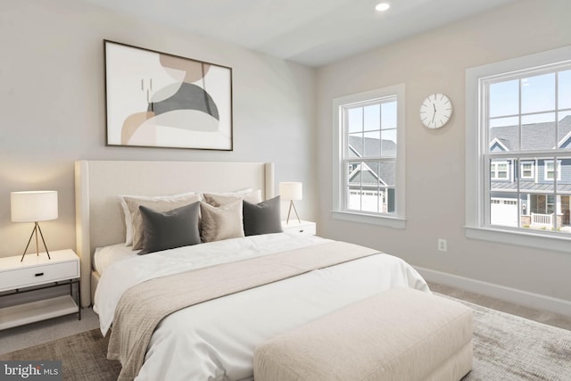 carpeted bedroom with multiple windows