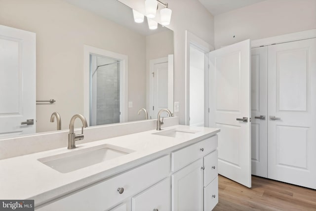 bathroom featuring vanity, wood-type flooring, and a chandelier