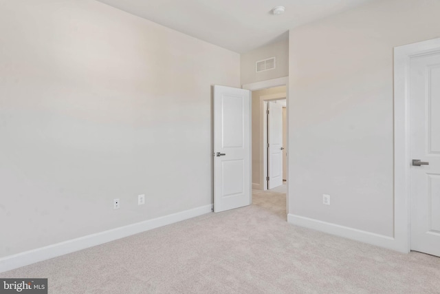 unfurnished bedroom featuring light carpet