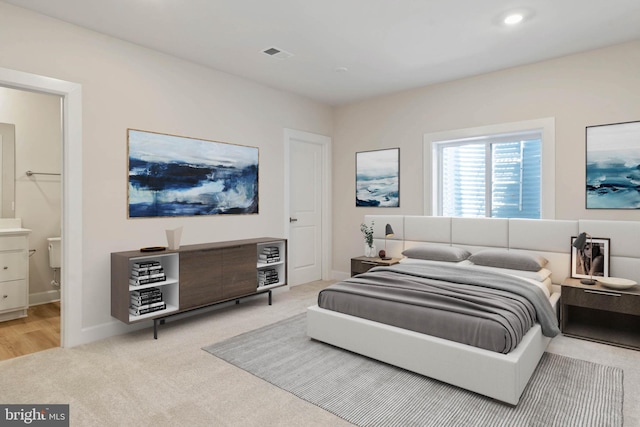 carpeted bedroom with ensuite bathroom