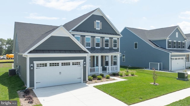 craftsman-style house featuring a garage, central AC, a front yard, and a porch