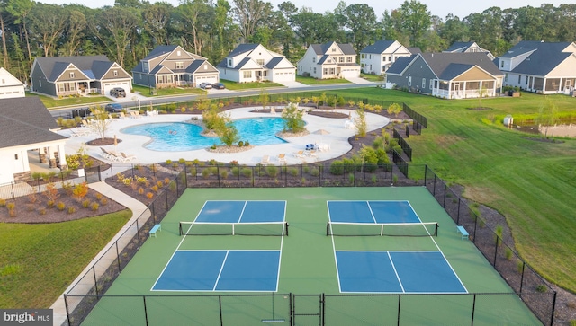 view of tennis court featuring a fenced in pool