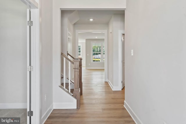 hallway with light hardwood / wood-style floors