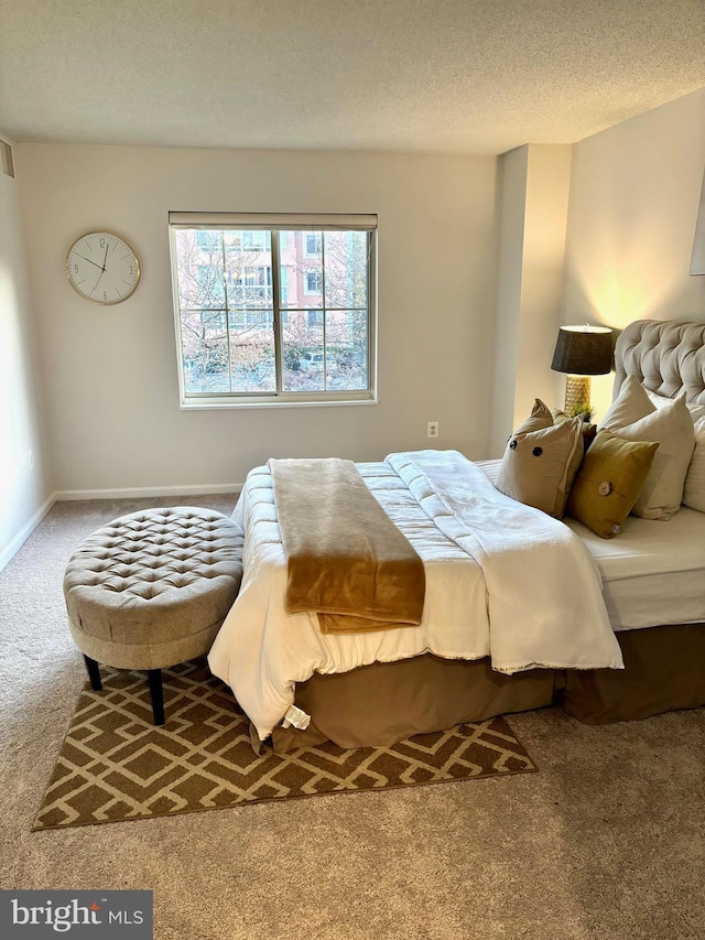 carpeted bedroom featuring a textured ceiling