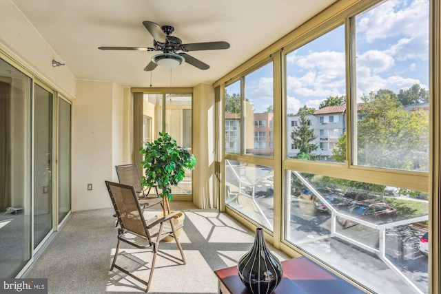 sunroom featuring ceiling fan