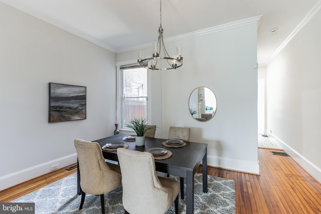 dining room featuring wood-type flooring and ornamental molding