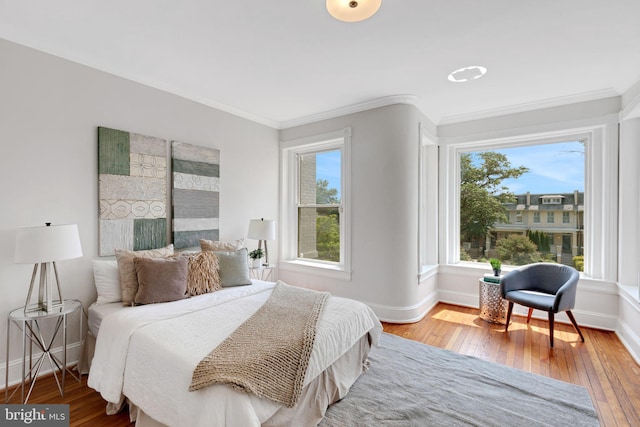 bedroom featuring wood-type flooring and crown molding