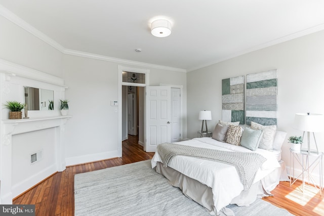 bedroom featuring crown molding and hardwood / wood-style flooring