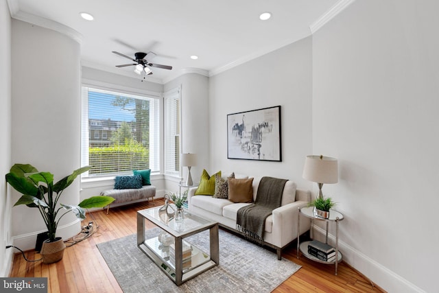 living room with ceiling fan, hardwood / wood-style flooring, and ornamental molding