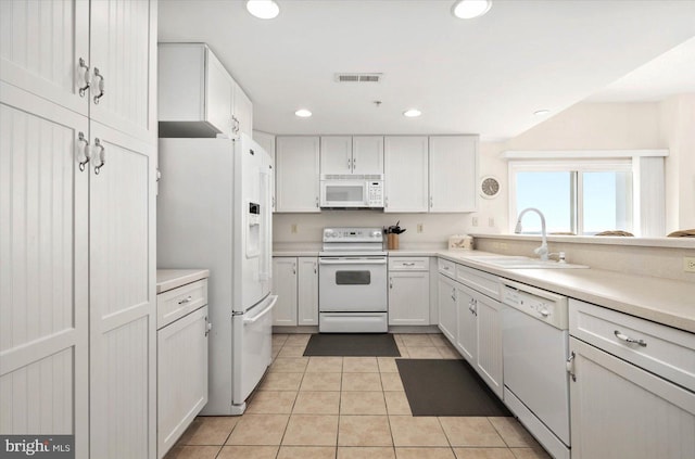 kitchen featuring sink, white appliances, and white cabinets