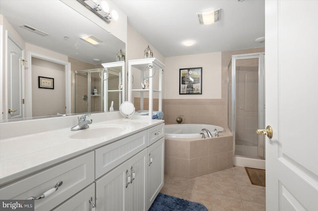 bathroom featuring tile patterned floors, independent shower and bath, and vanity