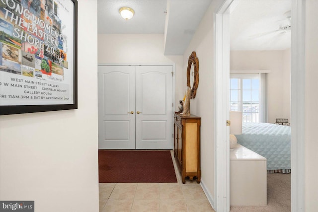 hallway featuring light tile patterned floors