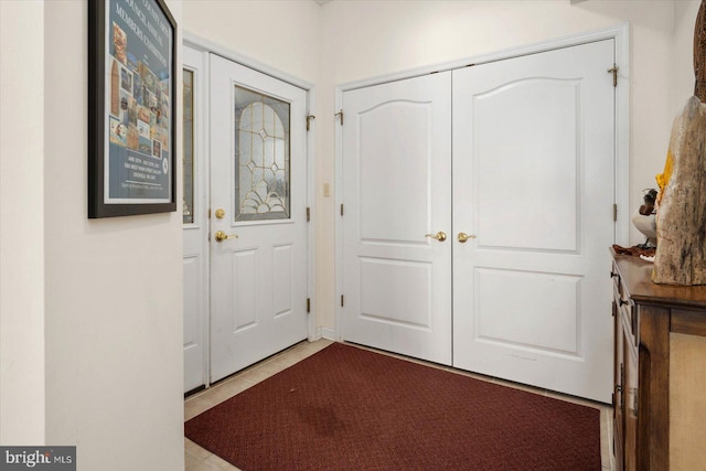 doorway featuring light tile patterned flooring