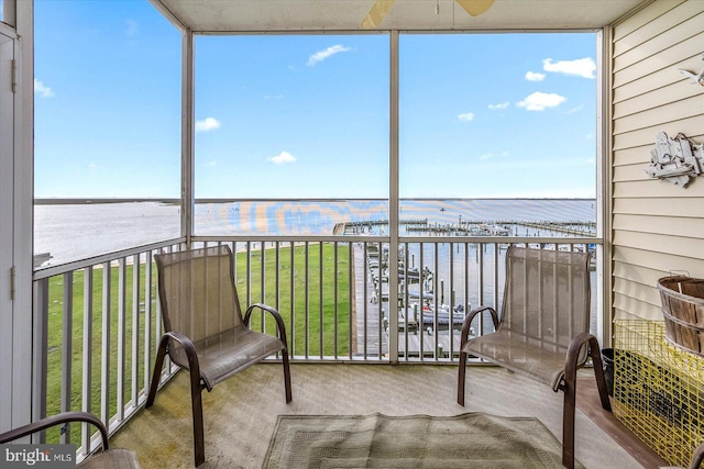 sunroom / solarium with a healthy amount of sunlight and a water view