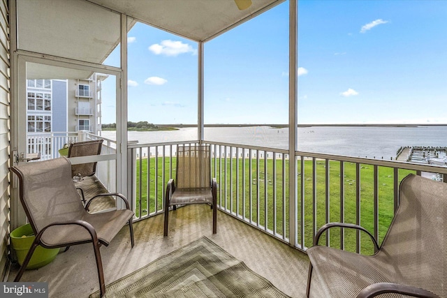 sunroom / solarium with a water view