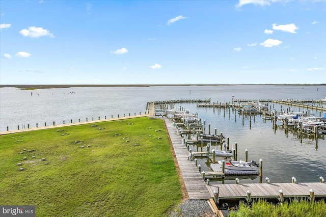 view of dock featuring a lawn and a water view