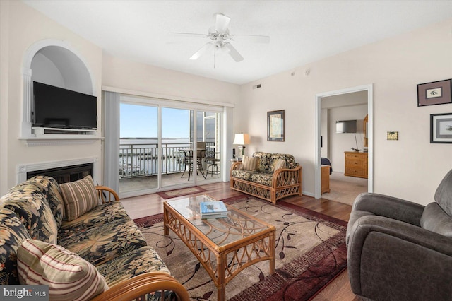 living room with ceiling fan and light hardwood / wood-style flooring