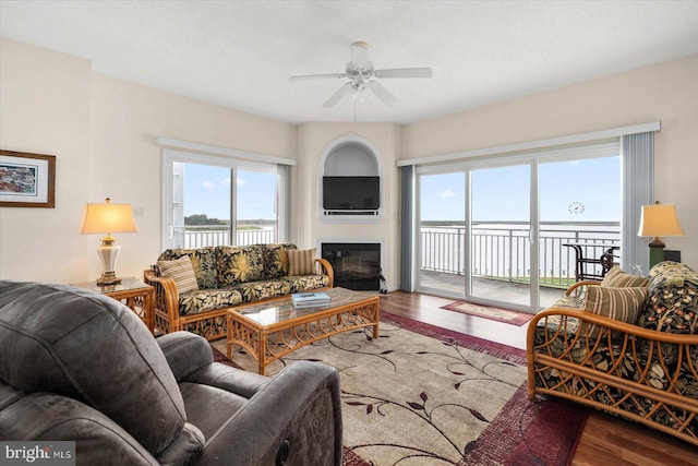 living room featuring ceiling fan, a wealth of natural light, and hardwood / wood-style flooring