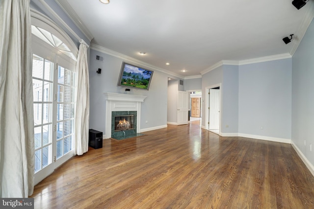 unfurnished living room with hardwood / wood-style floors, a fireplace, and ornamental molding