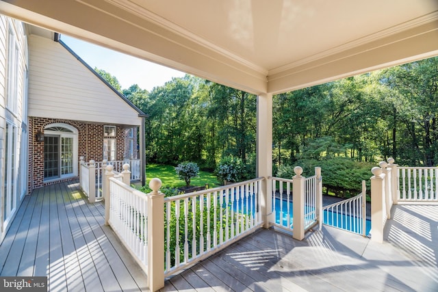 wooden deck with a swimming pool