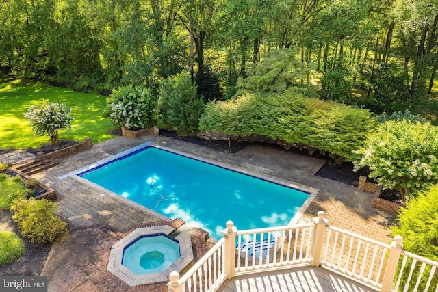 view of swimming pool featuring an in ground hot tub, a yard, and a patio